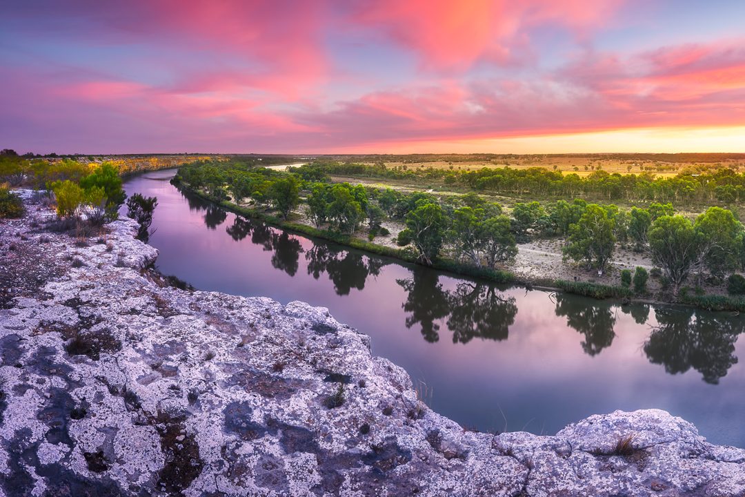 A river winding through rocky country at sunset